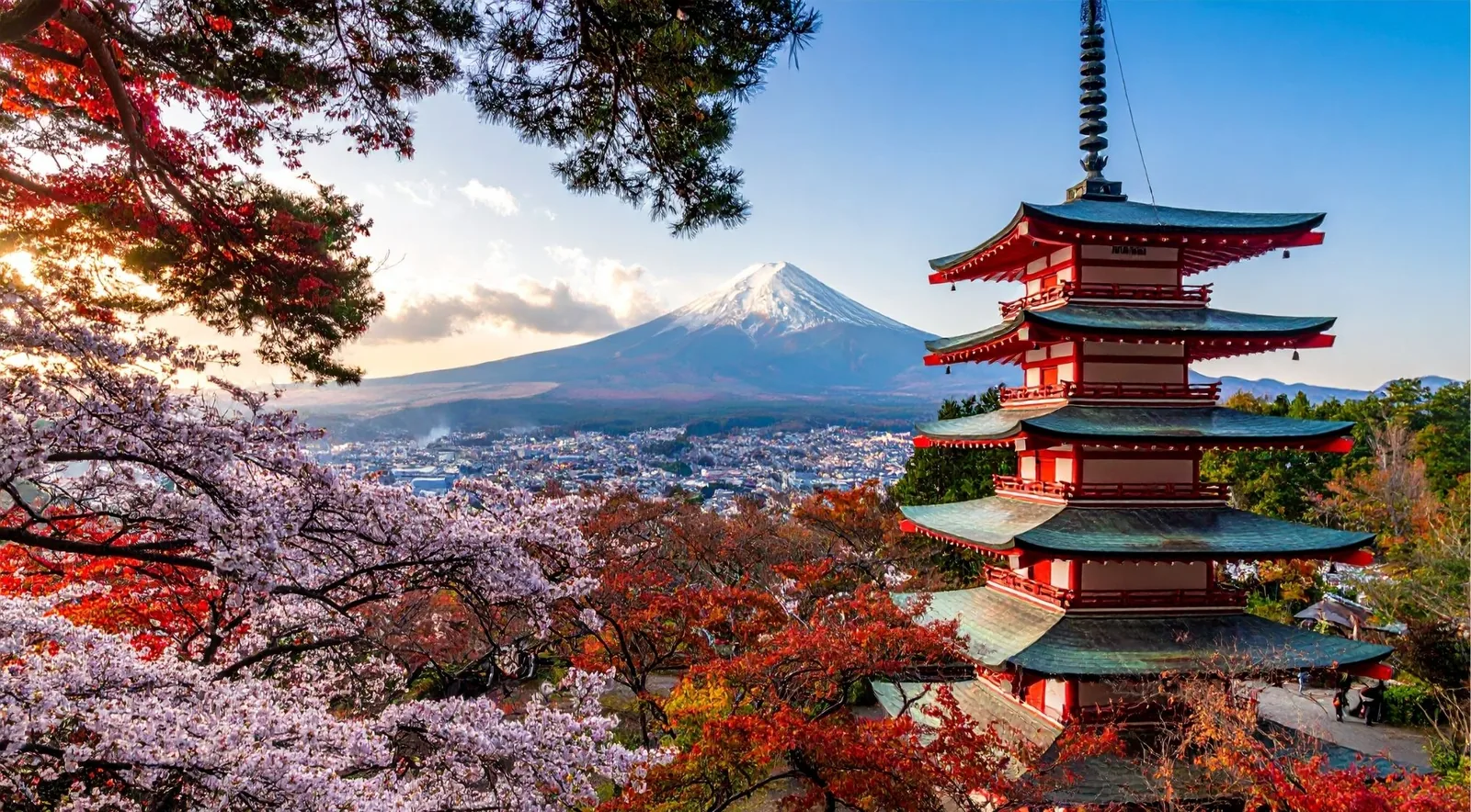 The vermilion Chureito Pagoda above Fujiyoshida with Mount Fuji behind it at sunset